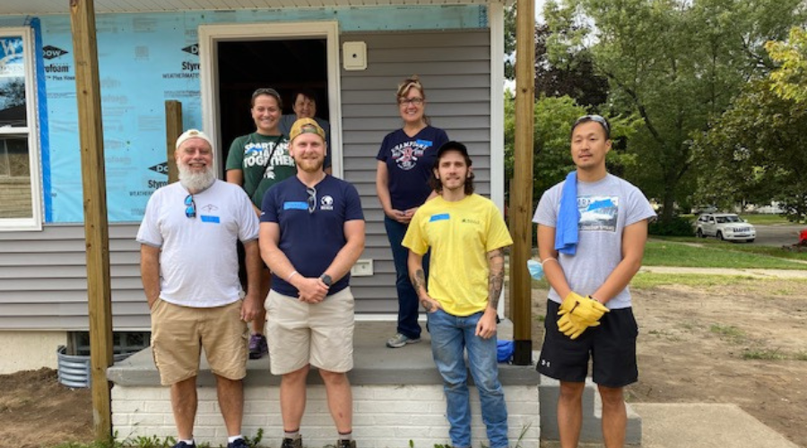 BB&E staff pose for a group photo at a Habitat for Humanity volunteering event.