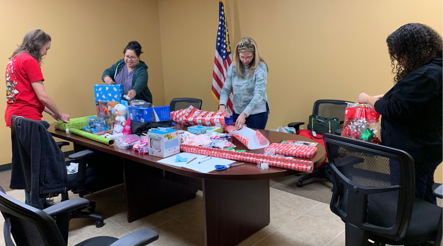 BB&E staff wrap Christmas presents for families in need.